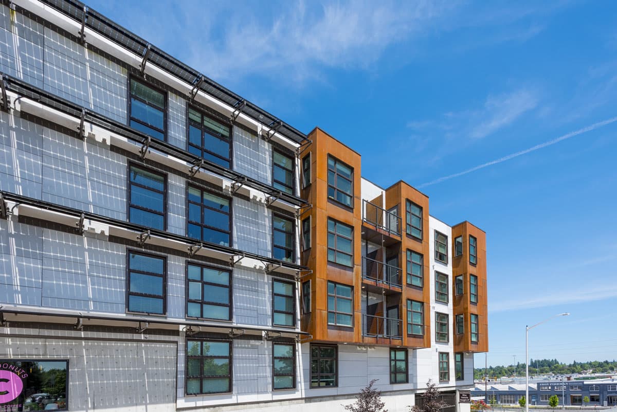 Brooklyn Yard in Portland's Brooklyn neighborhood, with solar panel awnings and orange wood-clad bays