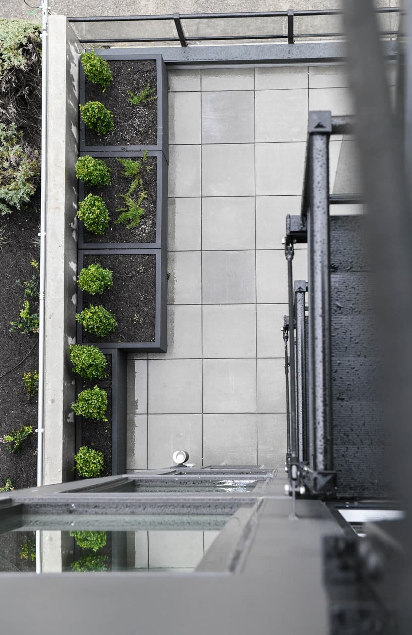 Overhead view of a LakeView balcony in Eastlake, Seattle, with pavers and a row of planted boxes
